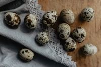 Kaboompics - Speckled Quail Eggs on Lace and Rustic Wood