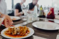 Kaboompics - Clams in Tomato Broth at a Restaurant Table with Diners