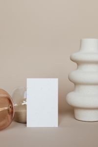 Kaboompics - Blank Business Card in Front of Hourglass and White Sculptural Vase, Warm Neutral Branding Mockup