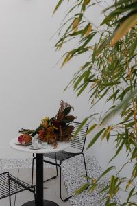 Kaboompics - Outdoor Coffeehouse Table with Croissant and Autumn Bouquet