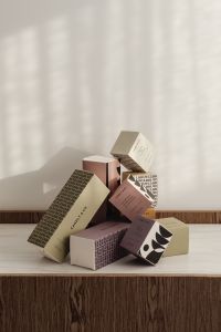 Kaboompics - Fragrance Packaging Boxes Arranged on a Wood Table