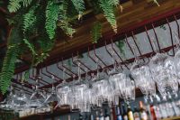 Kaboompics - A big bunch of wine glasses hanging from a holder