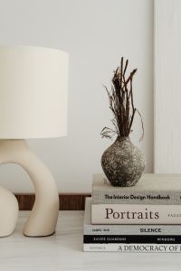 Kaboompics - Sculptural Ceramic Table Lamp and Wooden Bowl Styled on Design Books