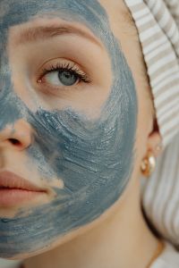 Kaboompics - Woman Wearing a Blue Clay Face Mask and Striped Towel Wrap