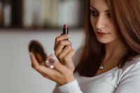 Kaboompics - Young beautiful woman doing her make up with lipstick