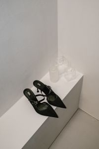 Kaboompics - Black Pointed Slingback Heels on White Ledge