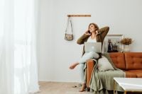 Kaboompics - Work from Home on a Cognac Sofa with Laptop and Phone Call