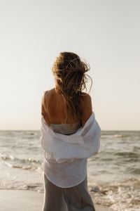 Kaboompics - Faceless Woman in White Shirt Standing by the Ocean