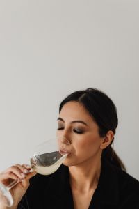 Kaboompics - Close-Up Asian Woman Sipping White Wine