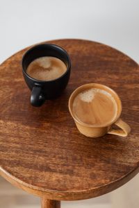 Kaboompics - Overhead View of Two Ceramic Coffee Cups on a Wooden Table
