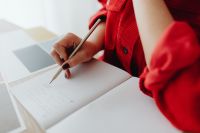 Kaboompics - Pencil Writing in Open Notebook beside Color Palette and Laptop, Home Office Detail