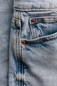 Kaboompics - Front of Light Wash Jeans with Copper Rivets, Coin Pocket and Belt Loop Details