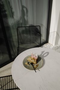 Kaboompics - Cake Slice with Pink Number Candle on a Round Table