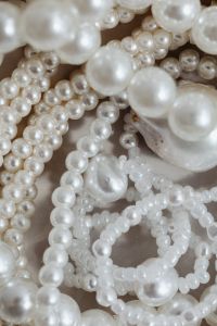 Kaboompics - Macro White Pearl Beads and Layered Necklace Strands in a Ceramic Dish, Jewelry Texture