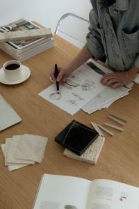 Kaboompics - Designer Drawing Architectural Concepts with Material Samples and Coffee
