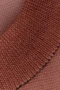 Kaboompics - Folded pink sheer knit fabric with gold trim detail