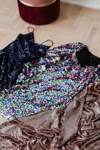 Kaboompics - colored sequin dresses lie on a wooden parquet