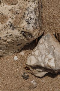 Kaboompics - Porous Shore Rock and Pebbles on a Sandy Beach