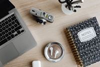 Kaboompics - Top View of Camera, AirPods and Notes Notebook