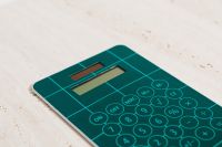 Kaboompics - Close-Up Teal Calculator on Textured Limestone, Minimal Math Education Background