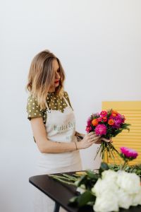 Kaboompics - Florist Standing Behind a Colorful Bouquet at a Worktable