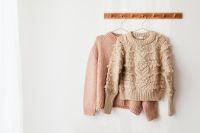 Kaboompics - Blush Pink Sweater Hanging on Wooden Rail