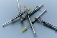 Kaboompics - Group of Medical Syringes on Blue Background