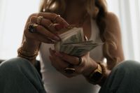 Kaboompics - Woman Holding Dollar Bills in Front of Her Face