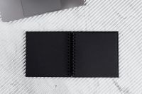 Kaboompics - Open Black Notebook and Laptop Corner on White Marble, Minimalist Work Desk