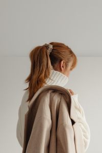 Kaboompics - Faceless Woman with Ponytail Wearing White Sweater and Beige Coat