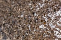 Kaboompics - Wet Pebble Shoreline with Sunlit Water Reflections and Natural Texture