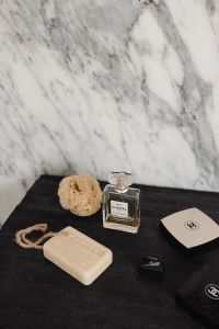 Kaboompics - Chanel No. 5 Perfume and Beauty Packaging on Black Surface