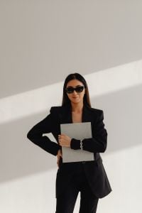 Kaboompics - Businesswoman in Sunglasses Holding a Laptop in a Black Suit