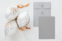 Kaboompics - White and Gold Baubles beside Gray String-Tie Envelope and Blank Card