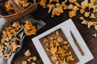 Kaboompics - Chanterelle Mushrooms On Wooden Cutting Board With Knife