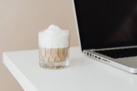 Kaboompics - Laptop and a glass of Cafe Latte on the desk