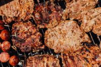 Kaboompics - Close Arrangement of Grilled Pork Neck Cuts and Sausage on the Grill