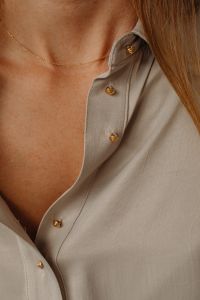 Kaboompics - Gold Chain Necklace on Tan Silk Shirt