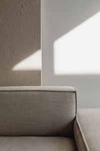 Kaboompics - Neutral Sofa with Geometric Sunlight and Textured Plaster Wall