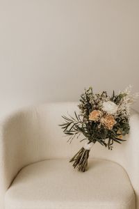 Kaboompics - Bridal Bouquet on a Light Upholstered Chair with Copy Space