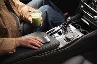 Kaboompics - Hand Resting by Iced Matcha in a Car