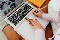 Kaboompics - Faceless Overhead View of Planner, Laptop and Writing Hand
