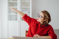 Kaboompics - Woman Pointing with Pencil toward Shelves beside Laptop at Home Office
