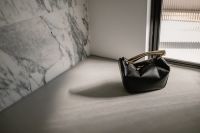 Kaboompics - Black Leather Handbag by Sunlit Window
