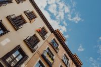 Kaboompics - Spanish Flags on Madrid Apartment Balconies Beneath a Blue Sky
