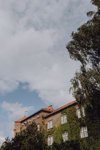 Kaboompics - Polish Flag above Historic Krakow Building beneath Clouds