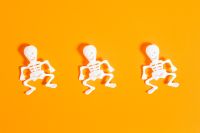Kaboompics - Three Mini Skeletons on Orange Background