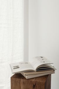 Kaboompics - Open Architecture Book with Copy Space beside Sheer Curtain