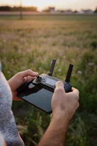 Man holding remote controller for drones flying