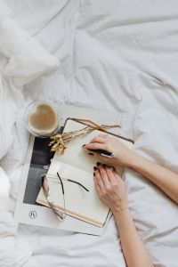In Bed with Notepad